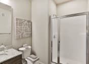 Thumbnail 15 of 28 - a bathroom with a shower and a sink and a toilet  at Aventura at Hawk Ridge, Lake St Louis