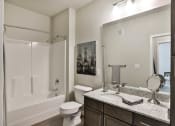 Thumbnail 17 of 28 - a bathroom with a shower toilet and sink at Aventura at Hawk Ridge, Lake St Louis, MO