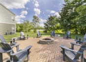 Thumbnail 27 of 31 - an outdoor patio with a firepit and adirondack chairs at Aventura at Richmond, St. Peters, MO, 63376