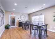 Thumbnail 21 of 31 - a dining area with a table and chairs and a large clock on the wall  at Aventura at Richmond, Missouri