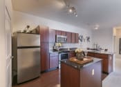 Thumbnail 4 of 31 - a kitchen with stainless steel appliances and wooden cabinets  at Aventura at Richmond, St. Peters, MO, 63376