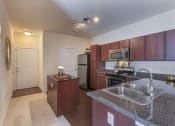 Thumbnail 6 of 31 - a kitchen with stainless steel appliances and granite counter tops  at Aventura at Richmond, St. Peters, Missouri