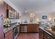 Thumbnail 2 of 31 - a kitchen with a stove top oven next to a sink  at Aventura at Richmond, Missouri