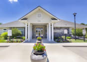 Thumbnail 1 of 37 - the front of a building with flowers in front of it at Aventura at Towne Centre, Missouri