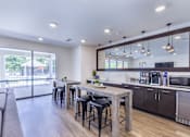 Thumbnail 4 of 37 - a living room with a kitchen and a dining table at Aventura at Towne Centre, Missouri, 63011