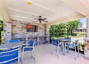 Thumbnail 18 of 37 - a patio with tables and chairs and a tv on the wall at Aventura at Towne Centre, Missouri, 63011