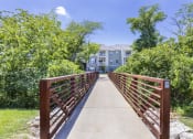 Thumbnail 11 of 37 - a bridge with a building in the background and trees at Aventura at Towne Centre, Missouri, 63011