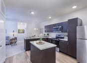 Thumbnail 27 of 37 - a kitchen with dark cabinets and a white counter top at Aventura at Towne Centre, Missouri, 63011