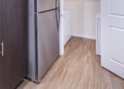 Thumbnail 25 of 37 - a kitchen with a refrigerator and a door to a closet at Aventura at Towne Centre, Ellisville, MO