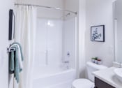 Thumbnail 31 of 37 - a bathroom with a shower and a toilet and a sink at Aventura at Towne Centre, Ellisville, 63011