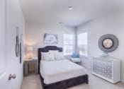 Thumbnail 32 of 37 - a bedroom with a bed and two windows at Aventura at Towne Centre, Ellisville