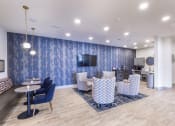 Thumbnail 7 of 29 - a lobby with chairs and tables and a television at Aventura at Wild Horse Creek, Chesterfield, 63017