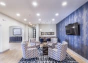 Thumbnail 8 of 29 - a living room with couches and a table and a television at Aventura at Wild Horse Creek, Chesterfield, Missouri