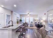Thumbnail 19 of 29 - a spacious living room with a kitchen and a living room at Aventura at Wild Horse Creek, Chesterfield, MO, 63017