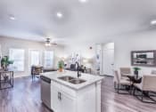 Thumbnail 21 of 29 - a spacious living room with a kitchen and a dining room at Aventura at Wild Horse Creek, Chesterfield