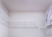 Thumbnail 27 of 29 - the walk in closet of a studio apartment with white shelves and a mirrored floor at Aventura at Wild Horse Creek, Chesterfield