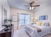 Thumbnail 28 of 29 - a bedroom with a bed and a ceiling fan at Aventura at Wild Horse Creek, Chesterfield