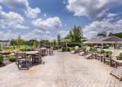 Thumbnail 18 of 29 - the outdoor patio at the preserve at great pond apartments in windsor ct at Aventura at Wild Horse Creek, Chesterfield, MO