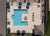 Thumbnail 14 of 16 - An aerial view of a pool surrounded by lounge chairs and umbrellas.