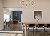 Thumbnail 22 of 41 - A dining room with a wooden table and chairs at Aventura at Wentzville I & II Apartments, Missouri, 63385