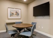Thumbnail 21 of 37 - a meeting room with a table and chairs and a flat screen tv at The Edison at Blue Springs, Blue Springs