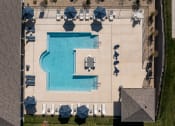 Thumbnail 3 of 28 - arial view of a swimming pool with tables and umbrellas  at Aventura at Hawk Ridge, Lake St Louis, Missouri