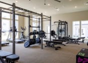 Thumbnail 12 of 37 - a fully equipped fitness room with weights benches and other exercise equipment at The Edison at Blue Springs, Blue Springs Missouri