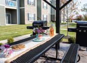 Thumbnail 29 of 31 - a patio with a table with food and drinks on it  at Aventura at Richmond, St. Peters, MO, 63376