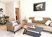 Thumbnail 8 of 31 - a living room with a couch and a table  at Aventura at Richmond, St. Peters
