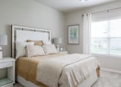 Thumbnail 4 of 37 - a bedroom with a bed and a window at The Edison at Blue Springs, Blue Springs, MO