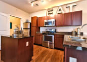 Thumbnail 2 of 22 - a kitchen with wooden cabinets and stainless steel appliances  at Aventura at Mid Rivers, St. Charles, 63304