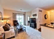 Thumbnail 5 of 22 - a living room with a couch and a table and a television  at Aventura at Mid Rivers, St. Charles, Missouri