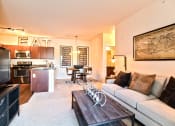 Thumbnail 7 of 22 - a living room and kitchen with a couch and a coffee table  at Aventura at Mid Rivers, St. Charles