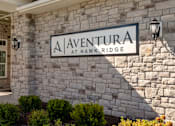 Thumbnail 5 of 36 - A sign that says "Aventura at Hawk Ridge" is mounted on a stone wall.