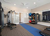 Thumbnail 30 of 41 - A gym with a variety of equipment including treadmills, weights, and a mirror at Aventura at Wentzville I & II Apartments, Wentzville, 63385