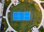 Thumbnail 2 of 37 - an aerial view of a tennis court and a house on the grass at The Edison at Blue Springs, Missouri, 64014