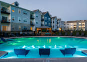 Thumbnail 26 of 37 - an apartment building with a large pool at night at The Edison at Blue Springs, Blue Springs, MO, Missouri, 64014