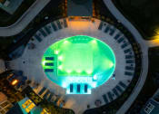 Thumbnail 24 of 37 - an overhead view of an indoor baseball stadium with green lights at The Edison at Blue Springs, Blue Springs