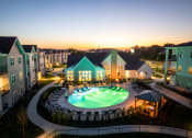 Thumbnail 1 of 37 - an aerial view of a resort pool at dusk at The Edison at Blue Springs, Blue Springs, MO, Missouri