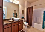 Thumbnail 13 of 31 - a bathroom with a sink and a toilet and a shower  at Aventura at Richmond, St. Peters, MO
