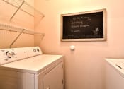 Thumbnail 16 of 31 - a washer and dryer in a laundry room with a chalkboard at Aventura at Richmond, St. Peters