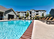 Thumbnail 24 of 31 - resort style pool area with lounge chairs at  Aventura at Richmond, Missouri