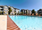Thumbnail 1 of 31 - large swimming pool with lounge chairs  at Aventura at Richmond, St. Peters, 63376