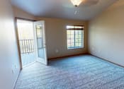 Thumbnail 26 of 28 - A room with a carpeted floor and a ceiling fan.