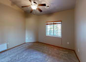 Thumbnail 23 of 28 - A room with a ceiling fan and a window.