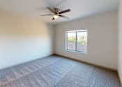 Thumbnail 19 of 28 - A room with a ceiling fan and a window.
