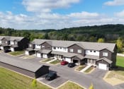 Thumbnail 1 of 12 - a aerial view of a group of houses and a parking lot