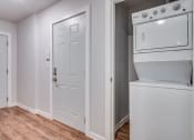 Thumbnail 18 of 26 - a laundry room with a washer and dryer and a white door