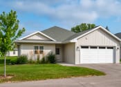 Thumbnail 13 of 24 - a white house with a garage and a driveway