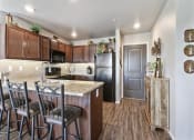 Thumbnail 12 of 41 - Kitchen with Granite Countertops and Breakfast Bar